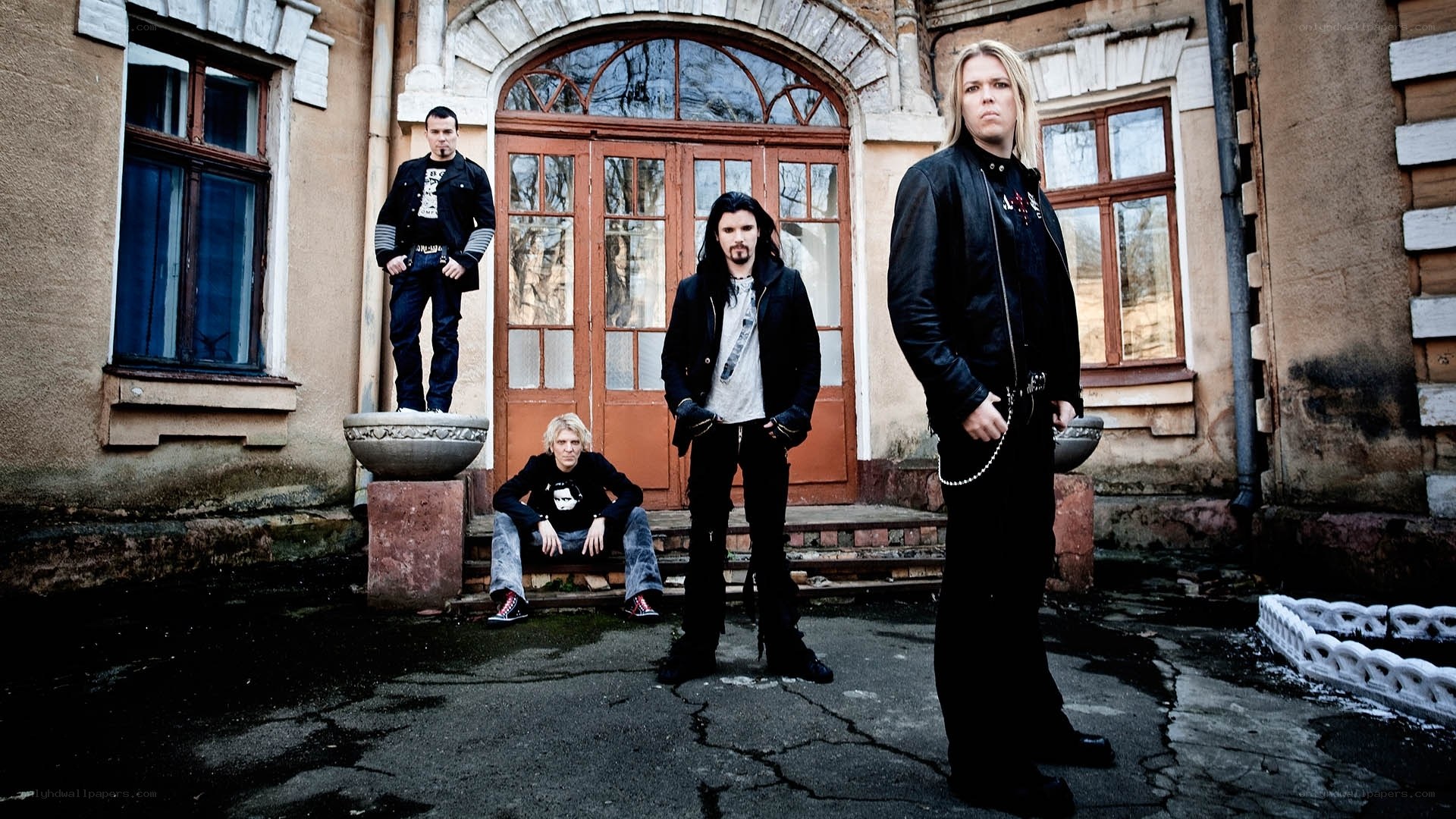 band members in front of old building