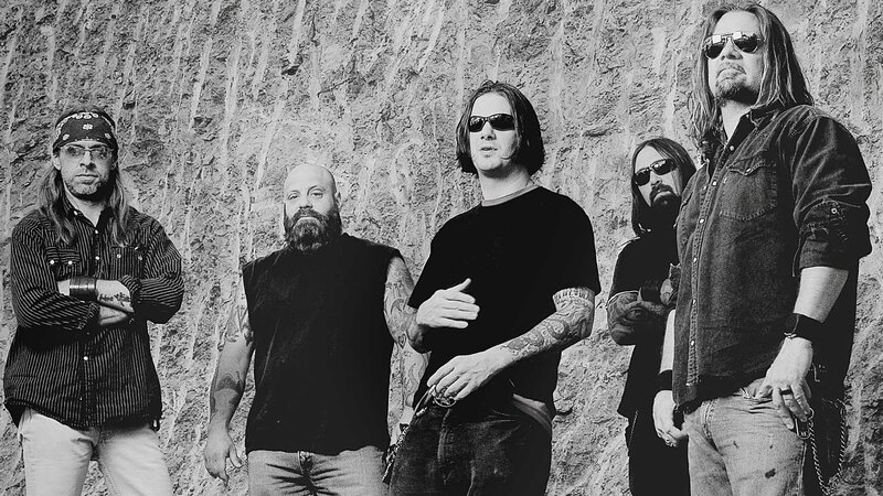 Band Members in Front of Rock