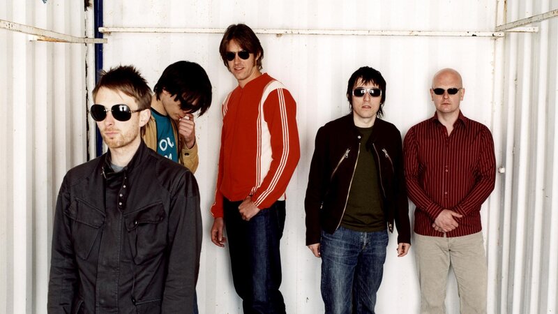 band members in front of shipping container