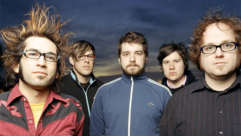 band members in front of sky