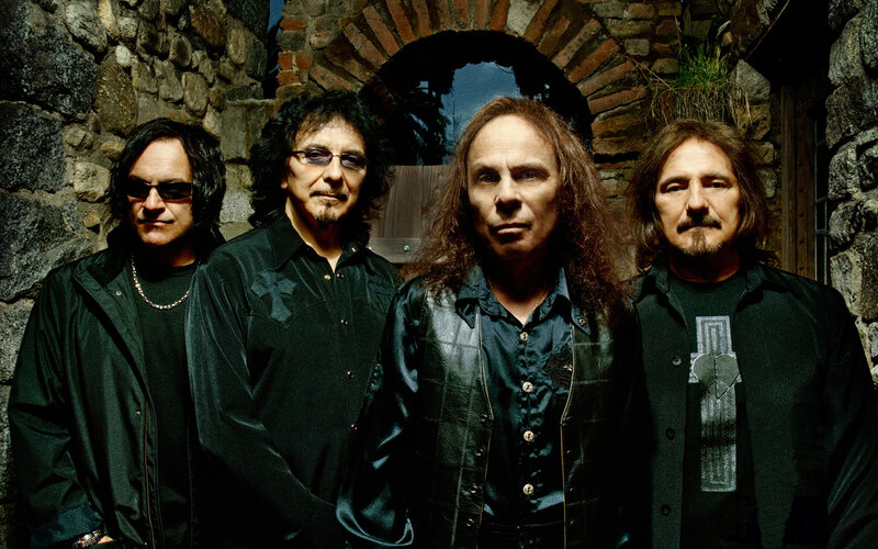 band members in front of stone wall