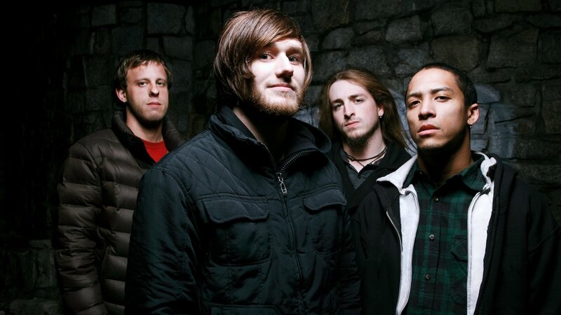 band members in front of stone wall