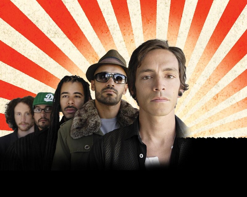 band members in front of sunburst