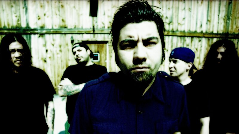 band members in front of wooden wall
