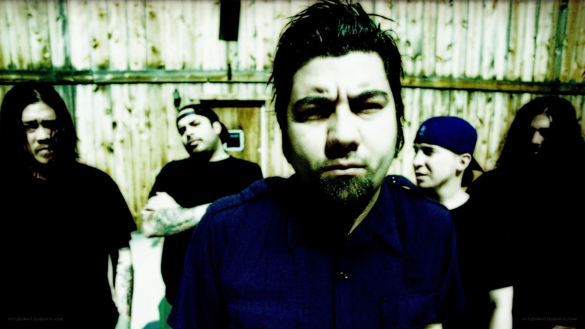 band members in front of wooden wall