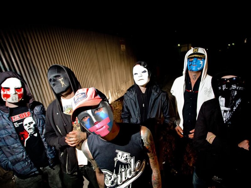 band members in masks at night