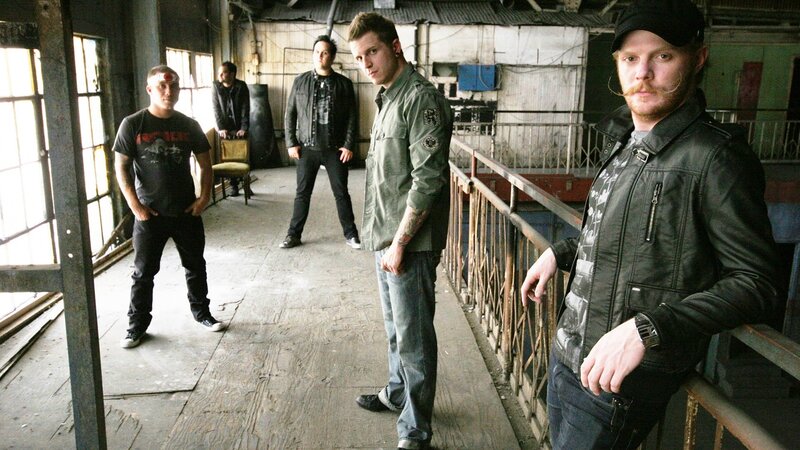 Band Members in Warehouse — Black, Serious