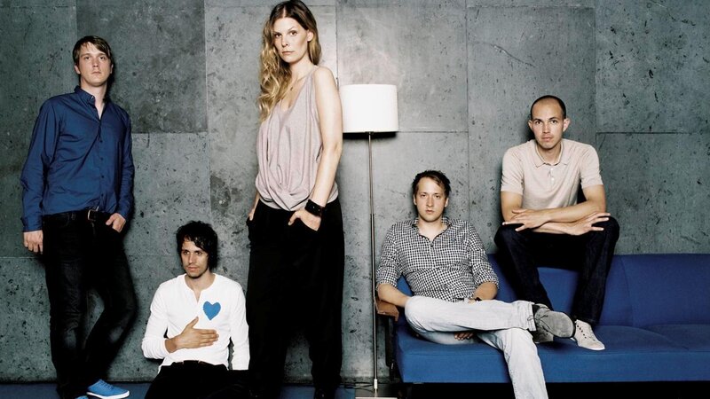band members on a blue couch