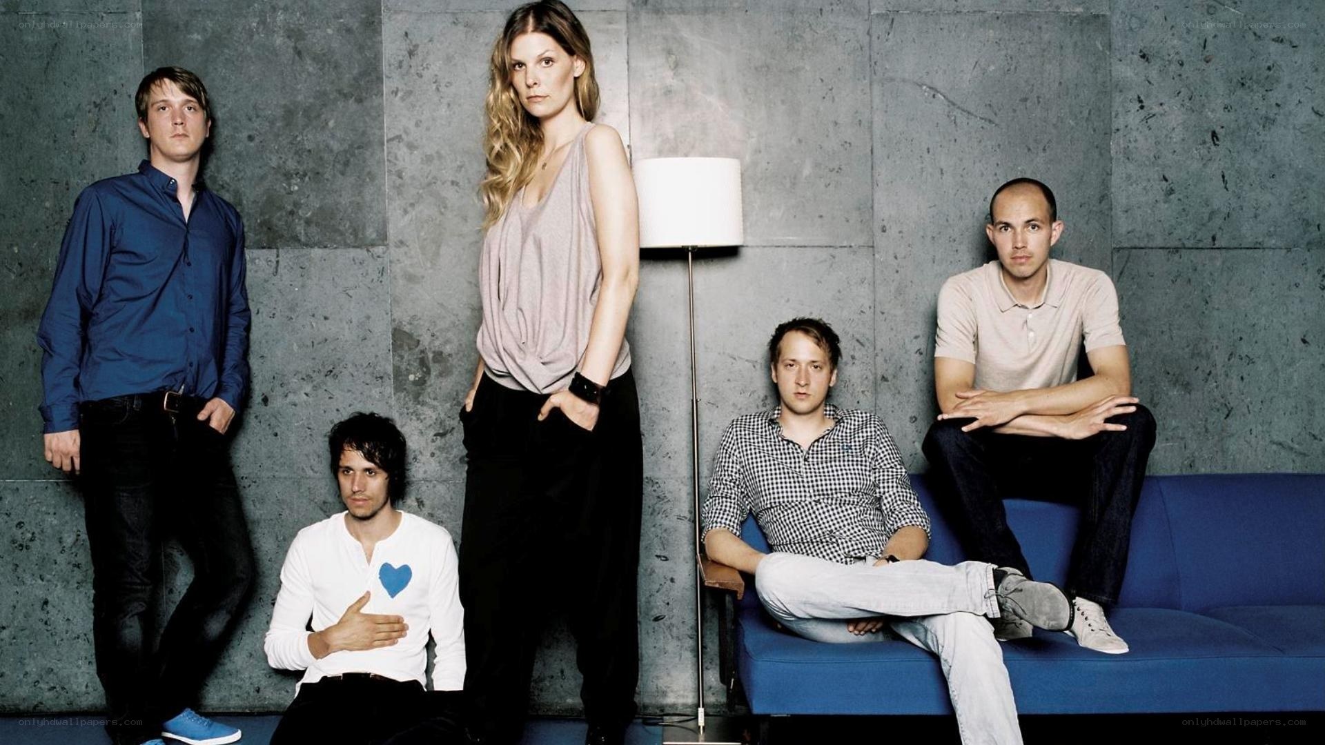 band members on a blue couch