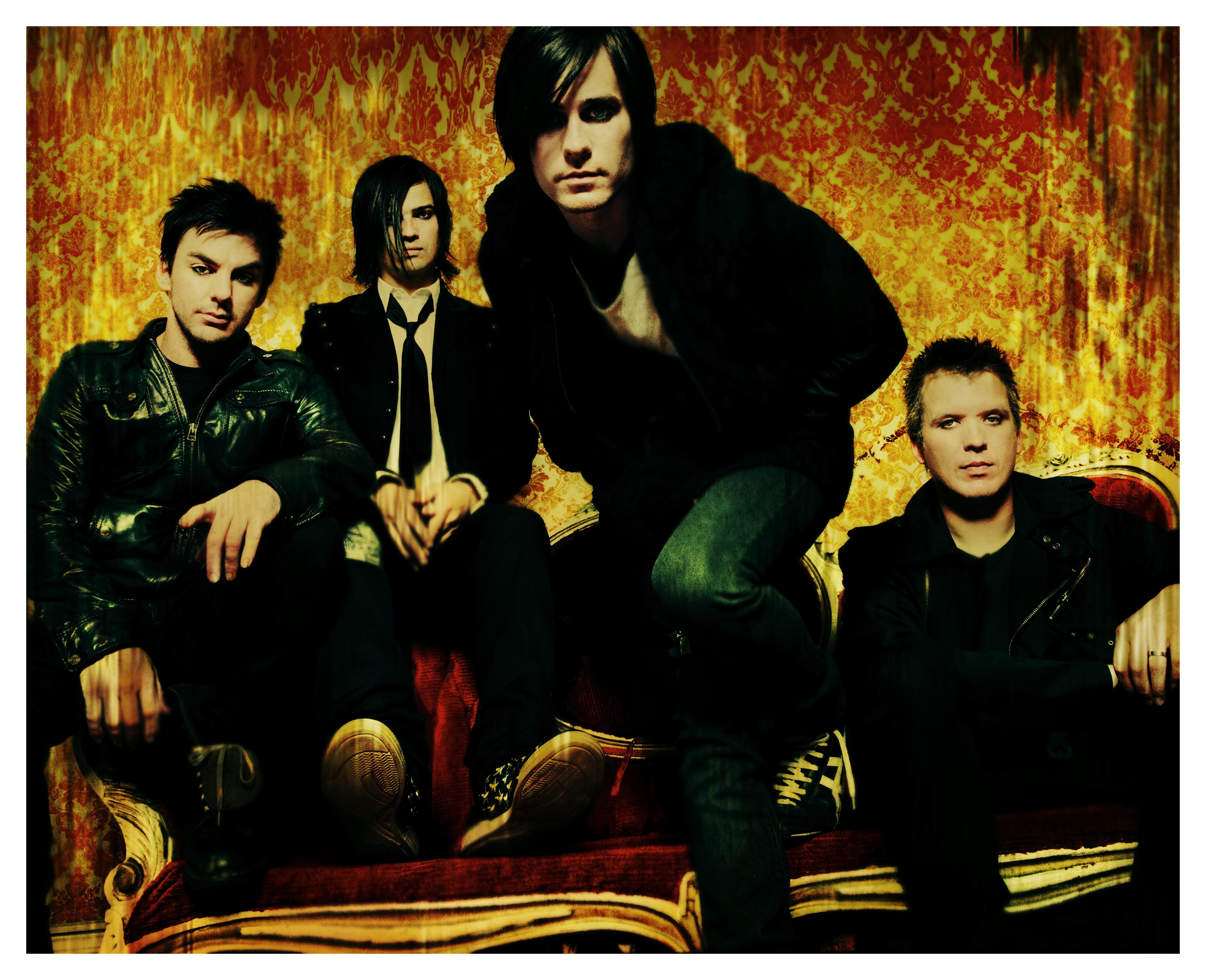 band members on ornate couch