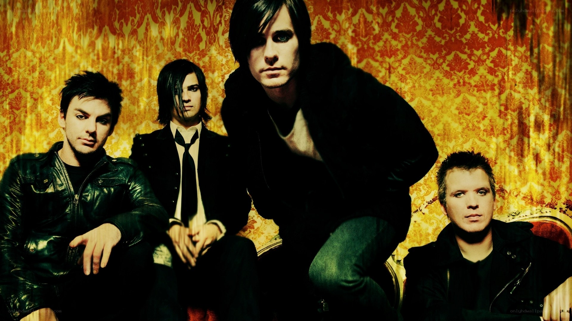 band members on ornate couch