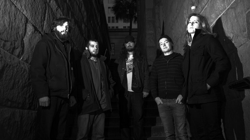 band members on stone steps