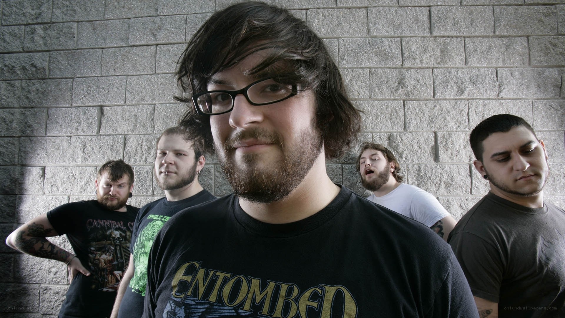 band members posing against wall