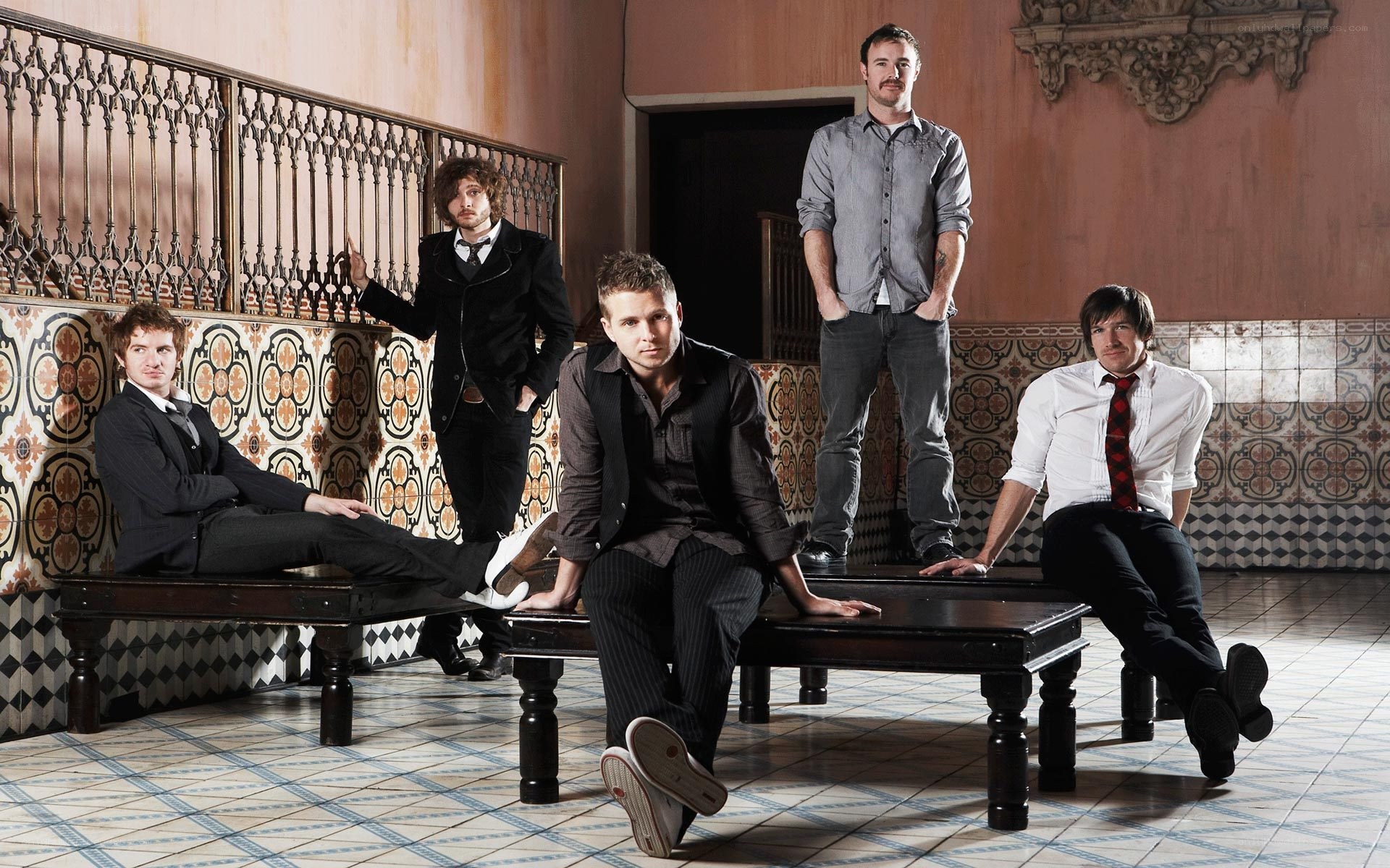 band members posing in ornate room