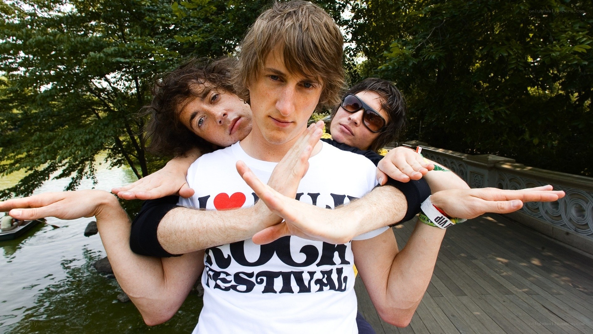 band members posing on a bridge