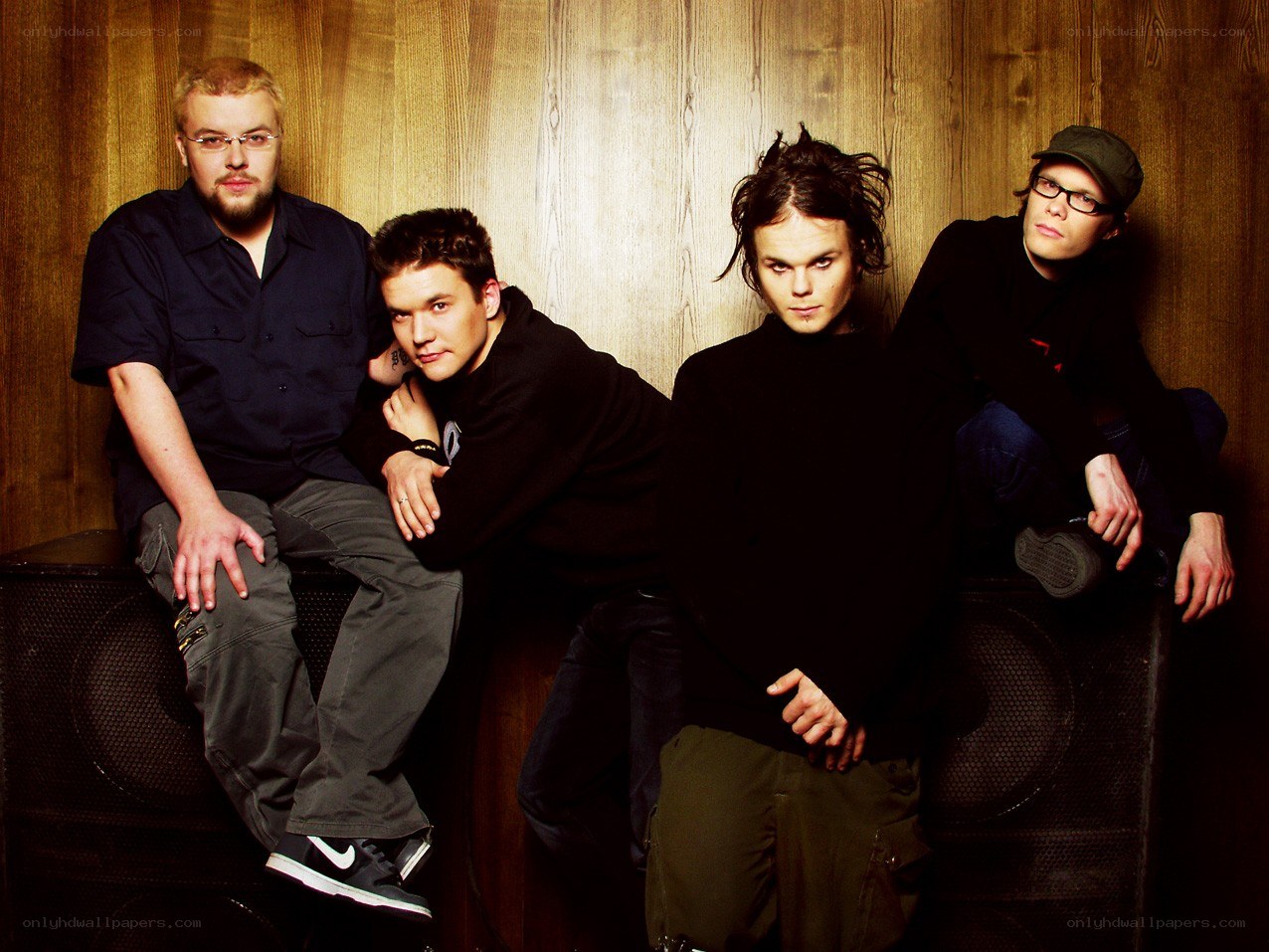 band members posing on speakers