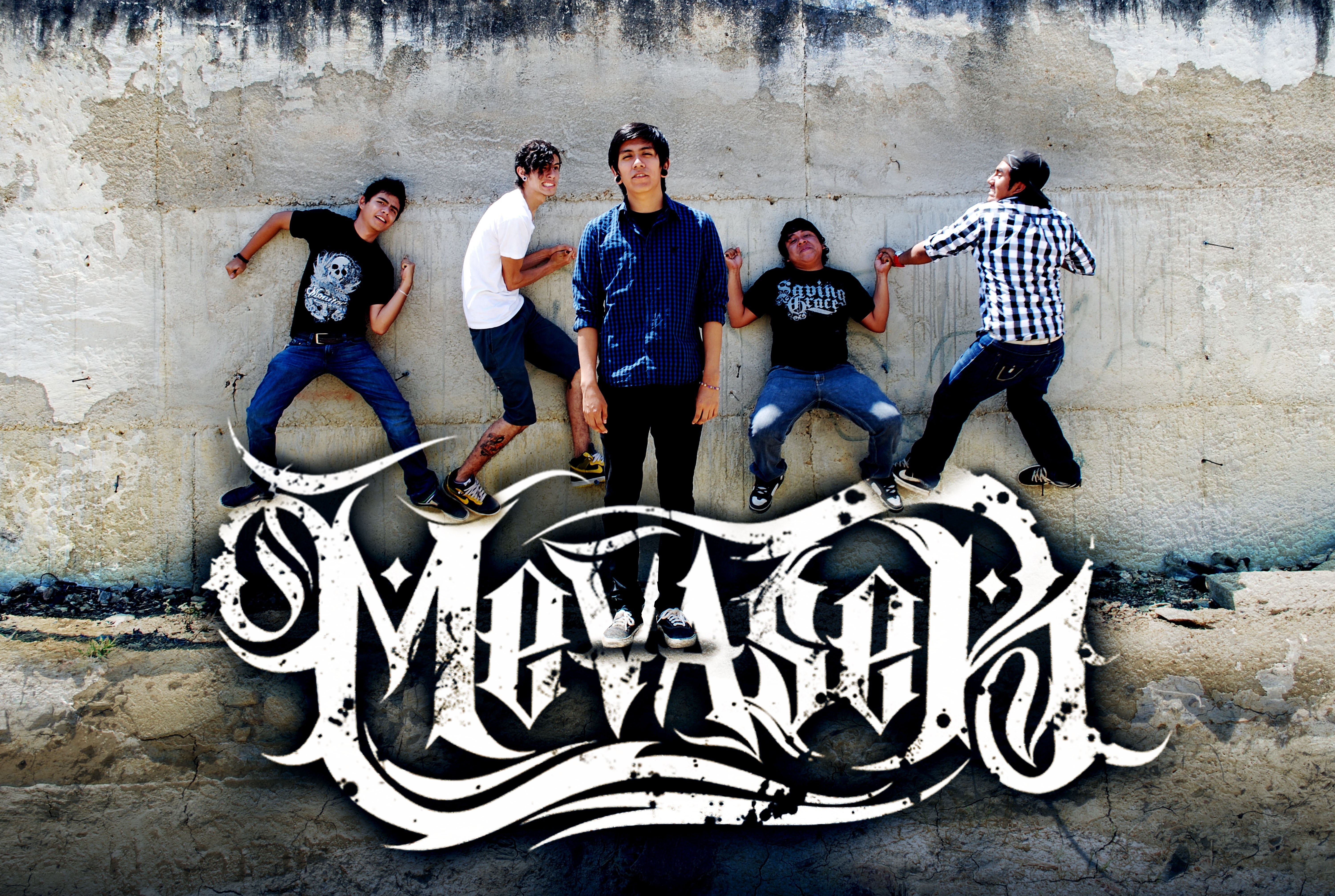 band members posing on wall
