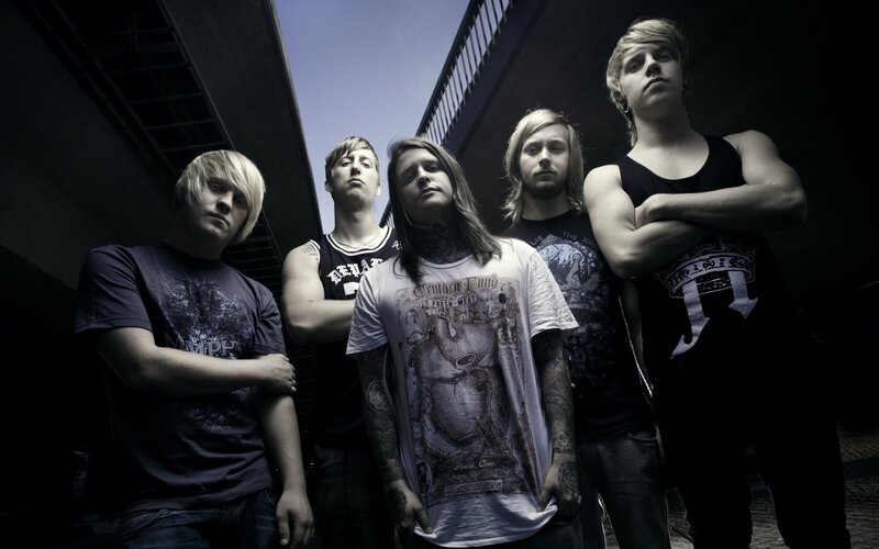band members posing under bridge