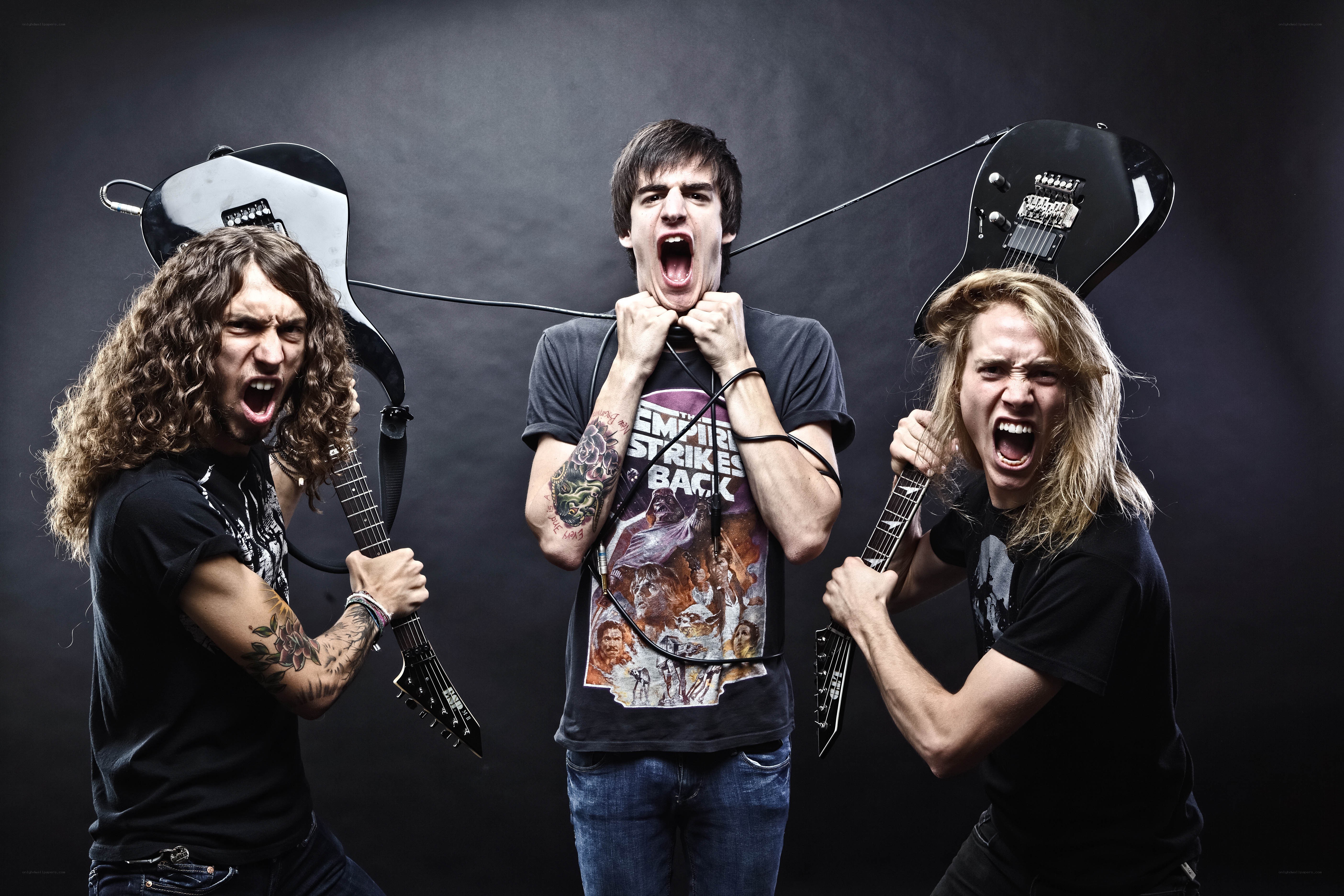 band members screaming with guitars
