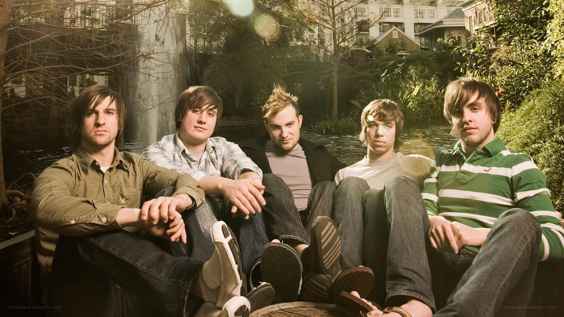 band members sitting by a pond
