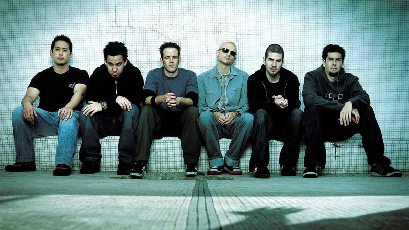 band members sitting on a bench