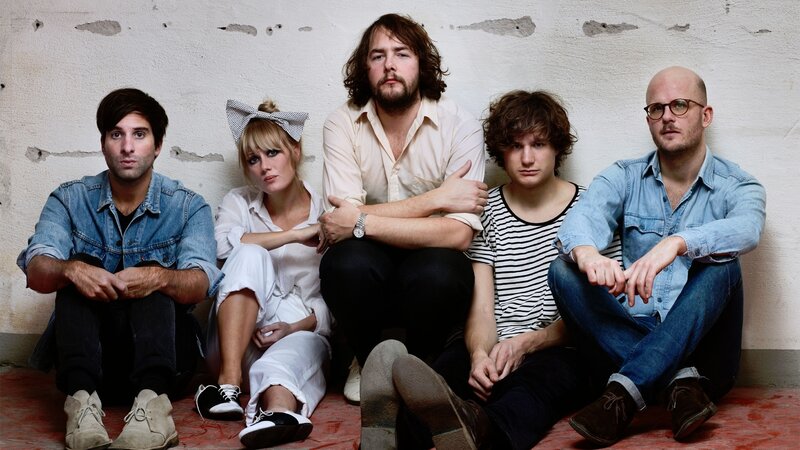 band members sitting on floor