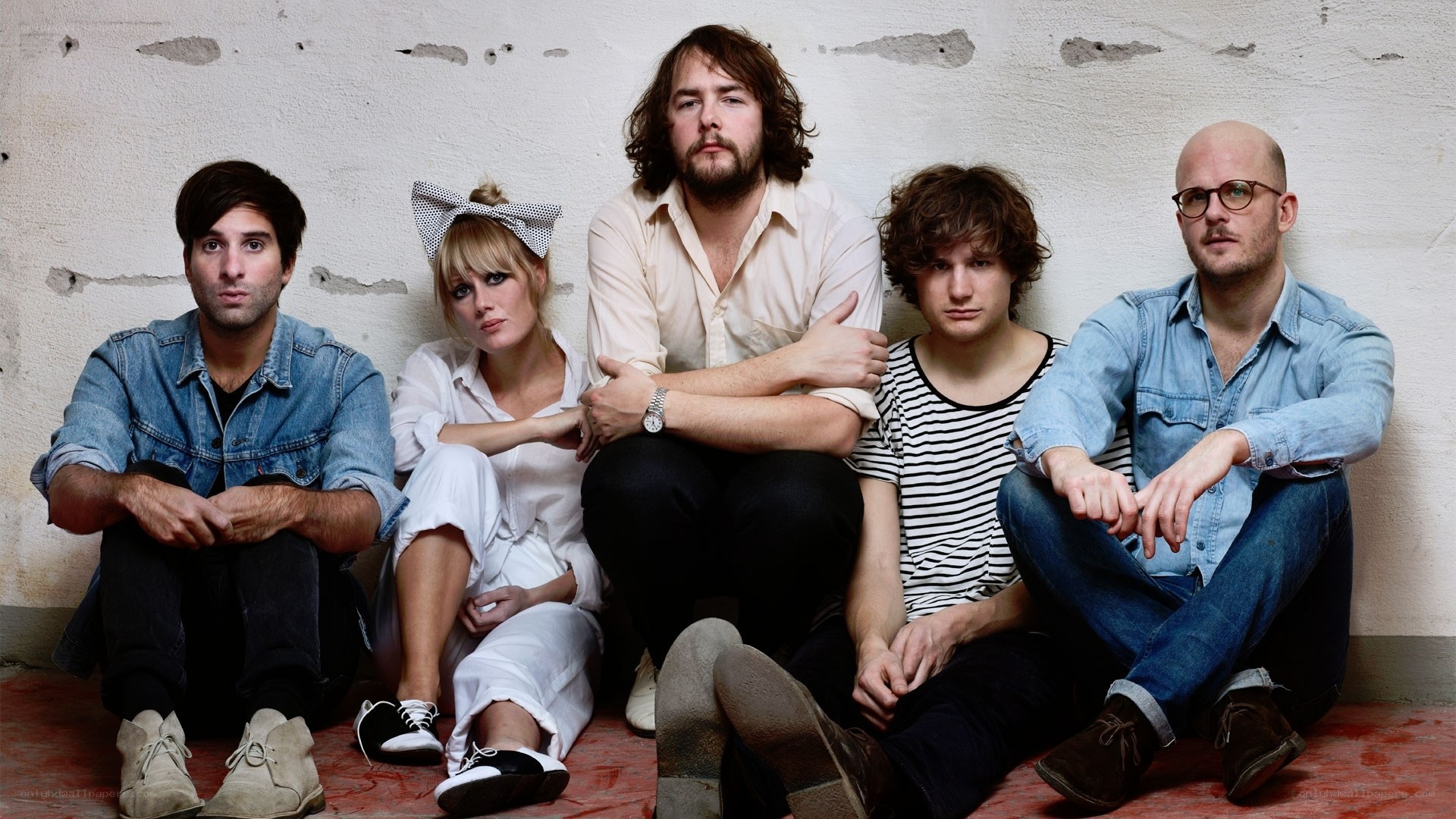 band members sitting on floor