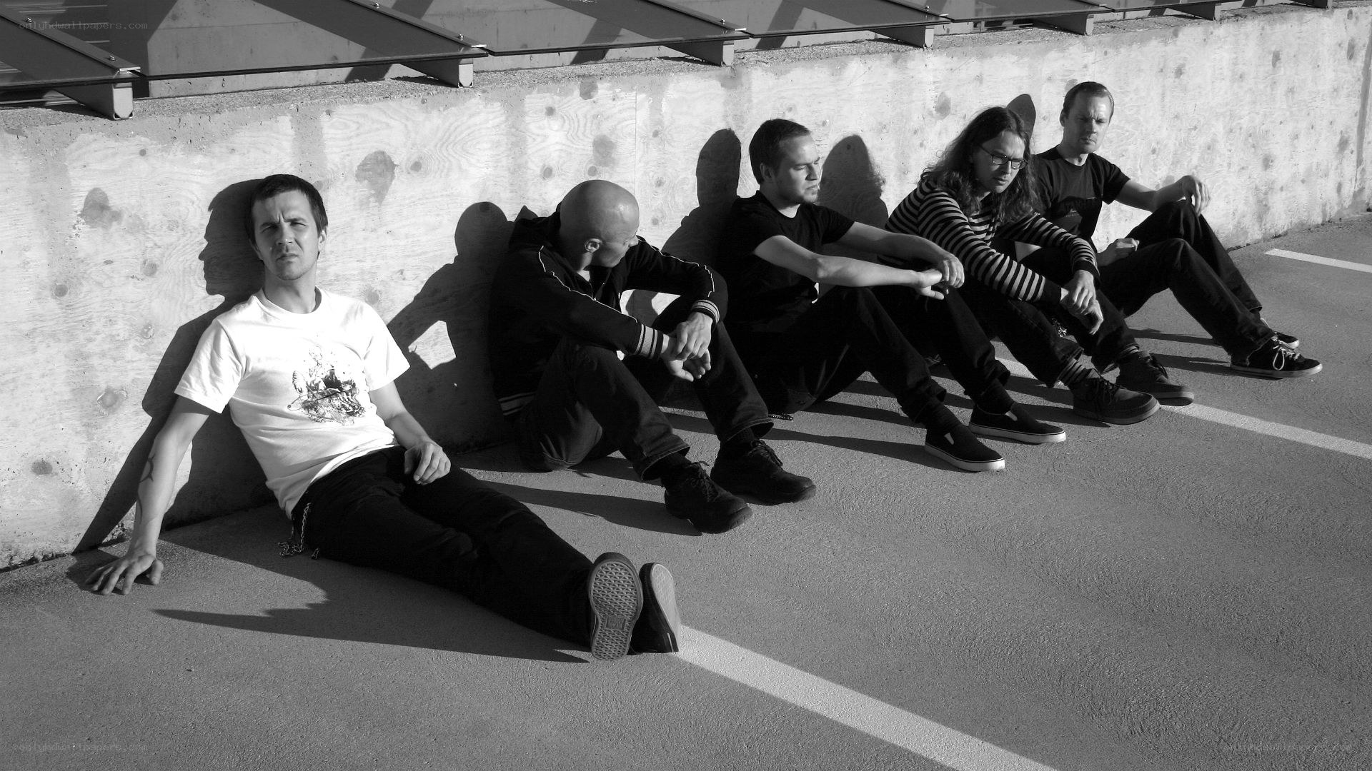 band members sitting on pavement