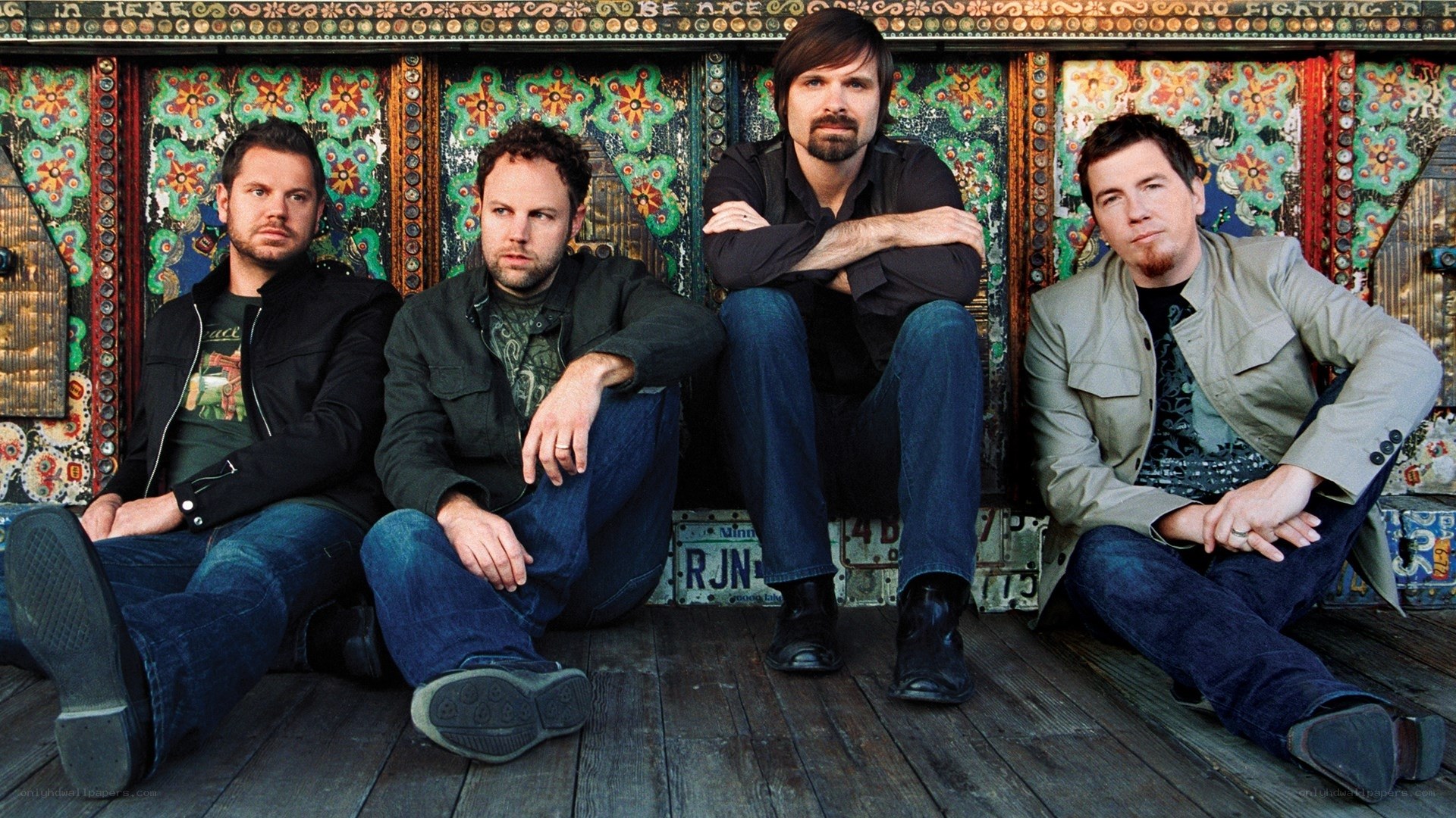 band members sitting on stage