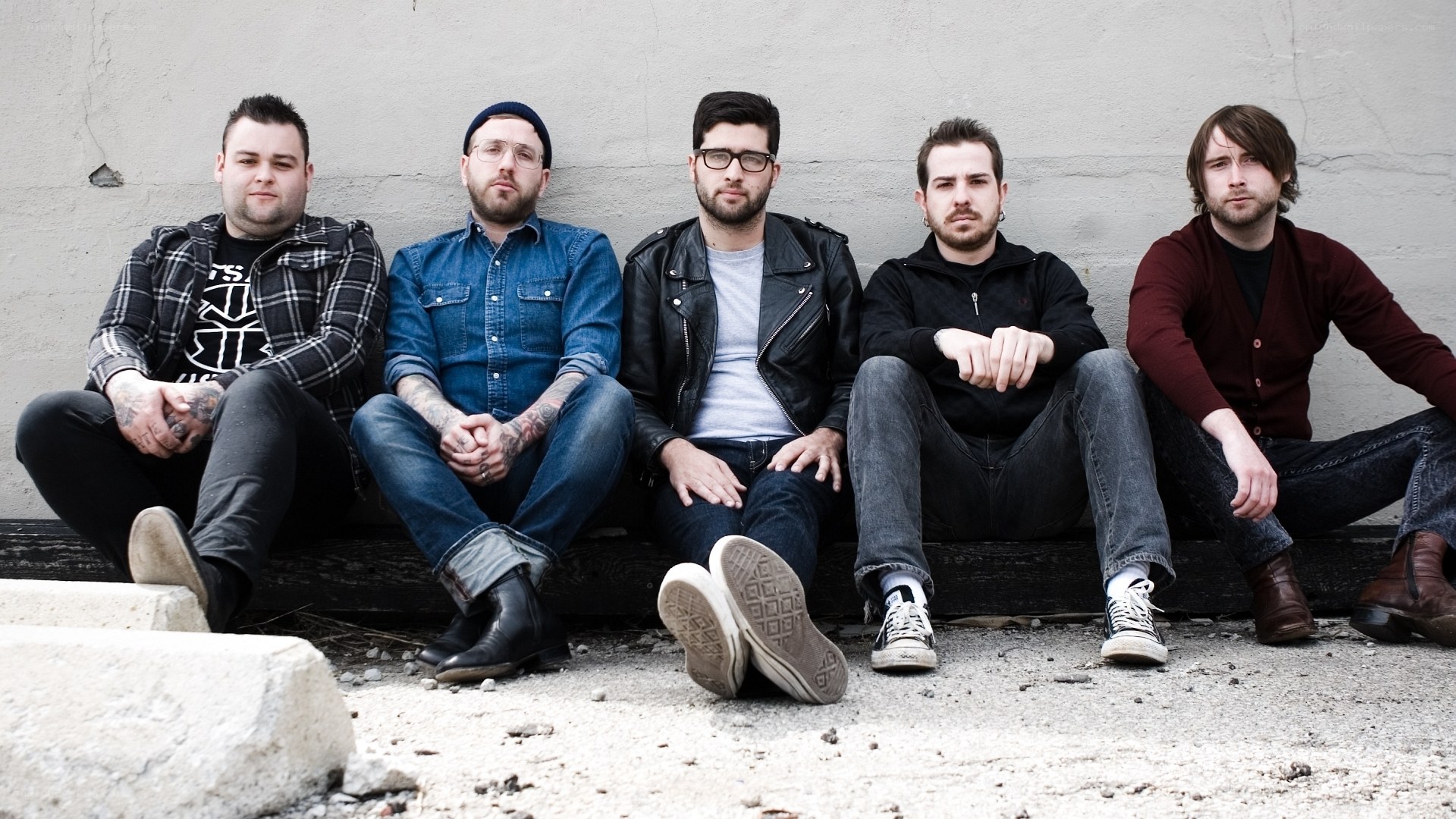 band members sitting on steps