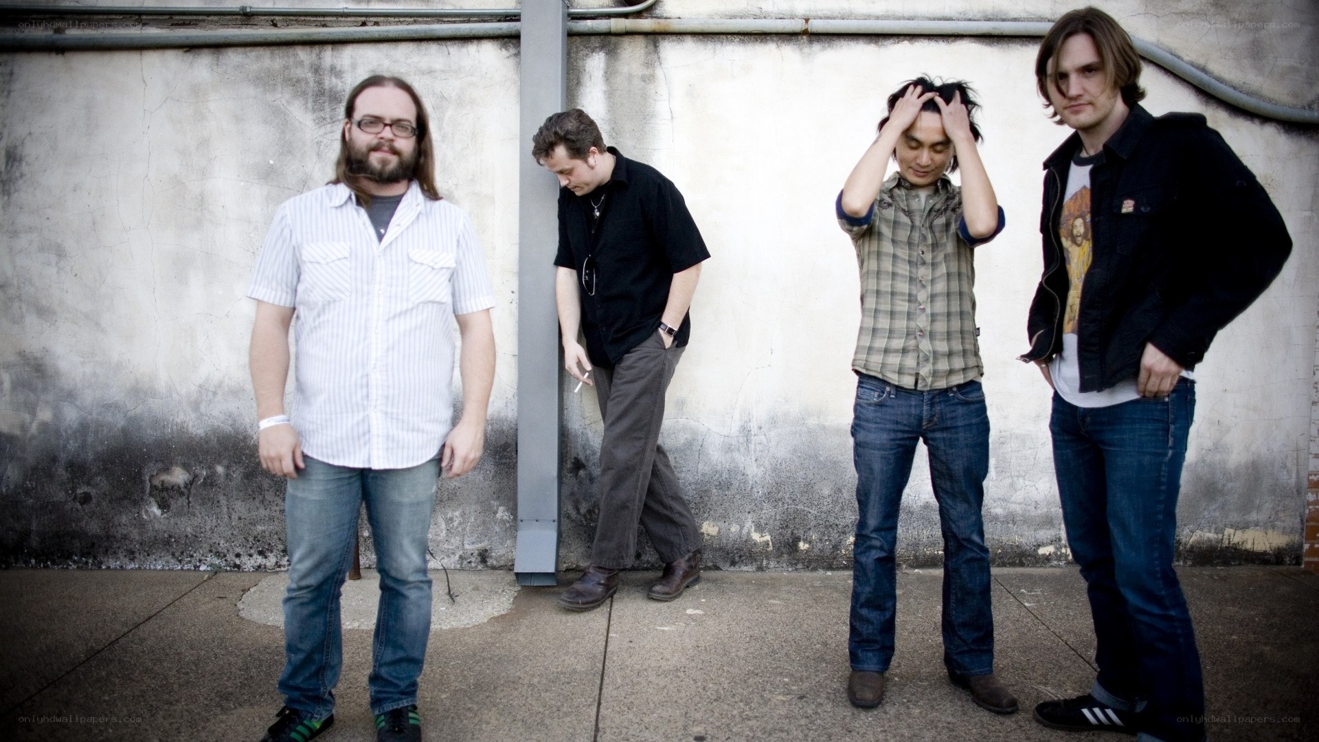 band members standing against wall