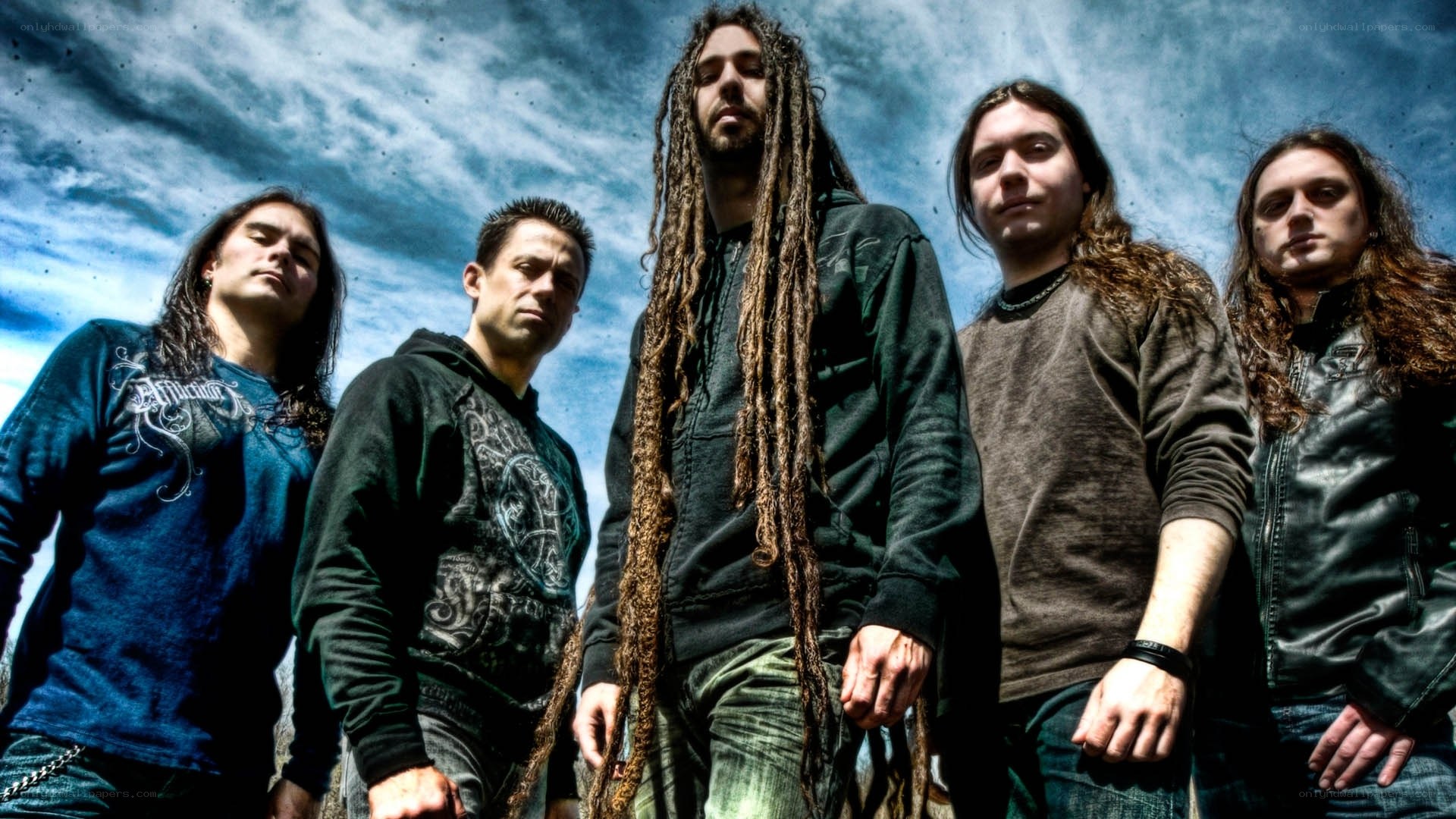 band members under cloudy sky
