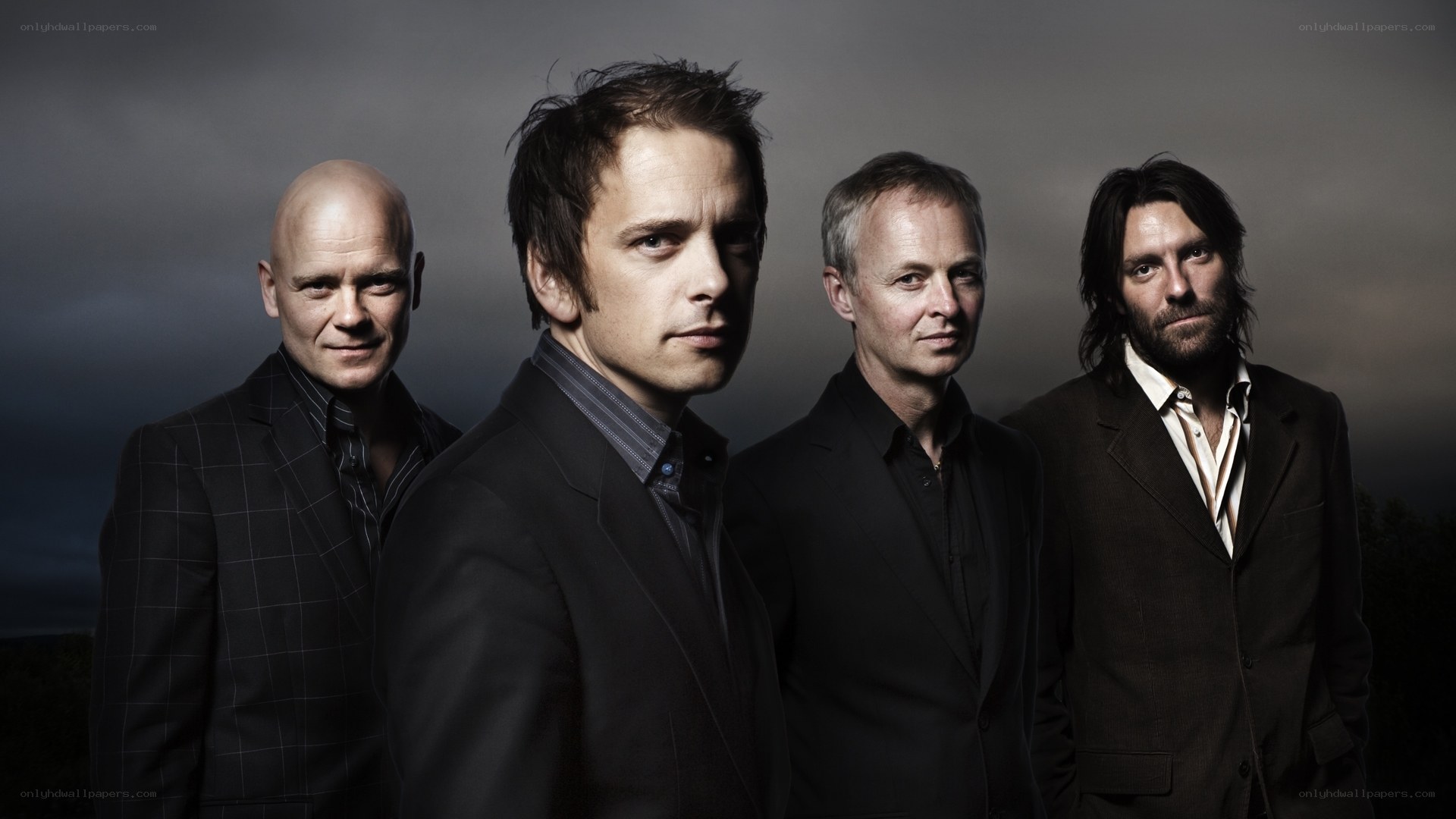 band of four men in suits