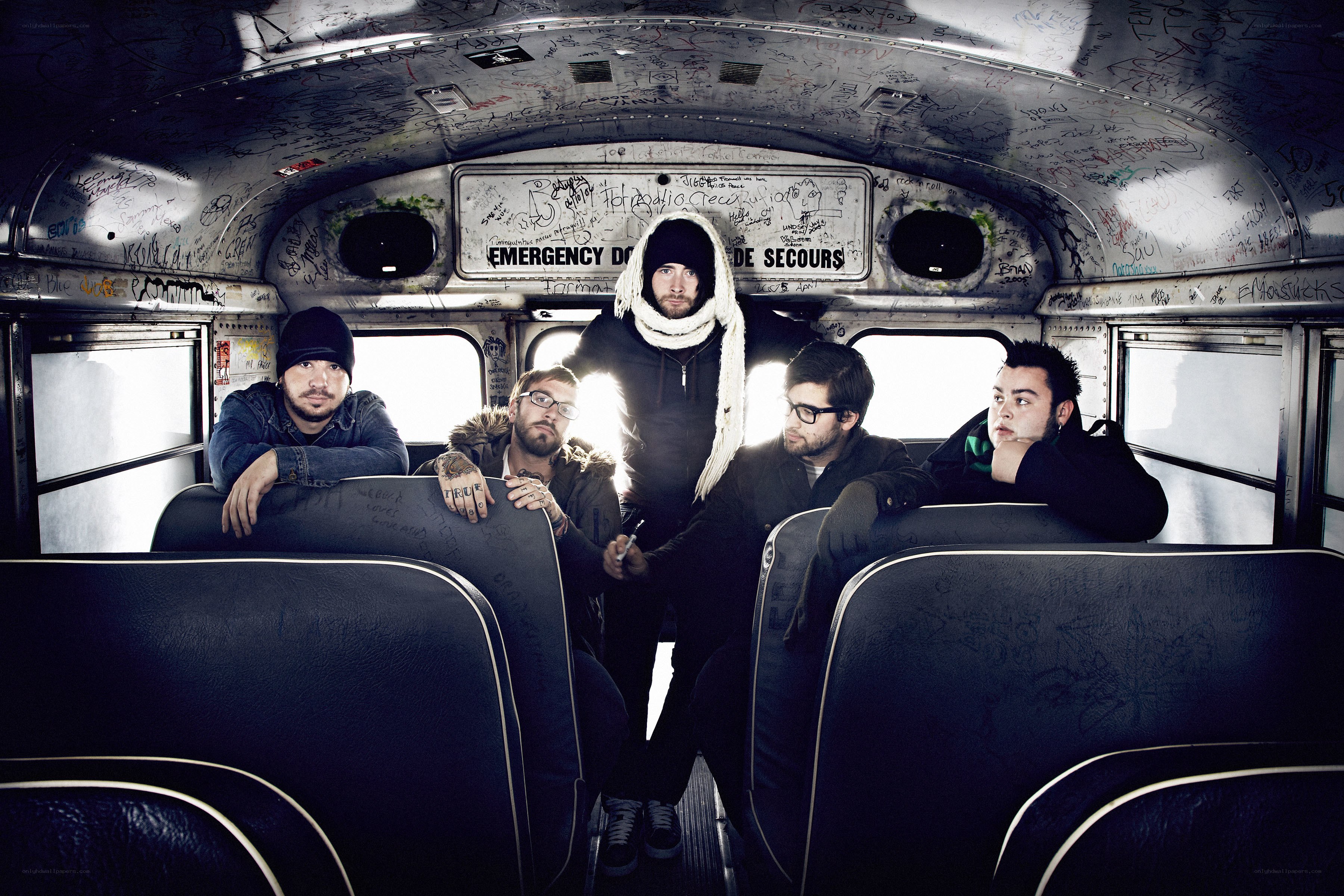 band on a graffiti-covered bus