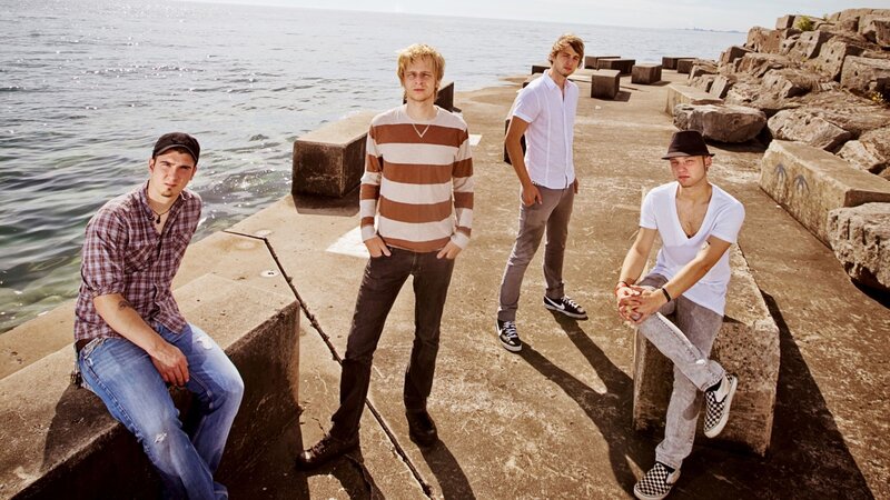 band on a pier by the water