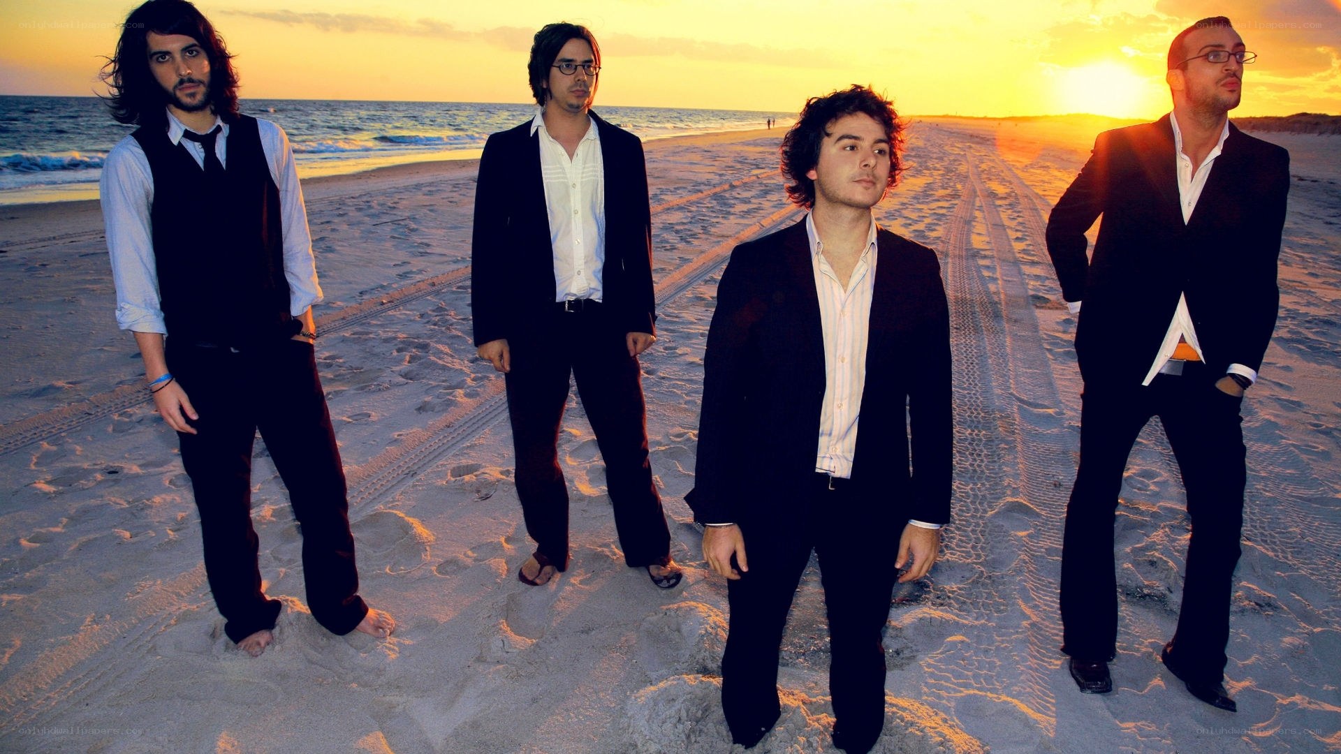 band on beach at sunset