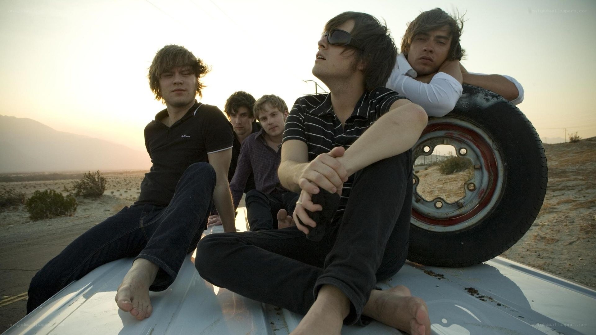 band on car roof at sunset