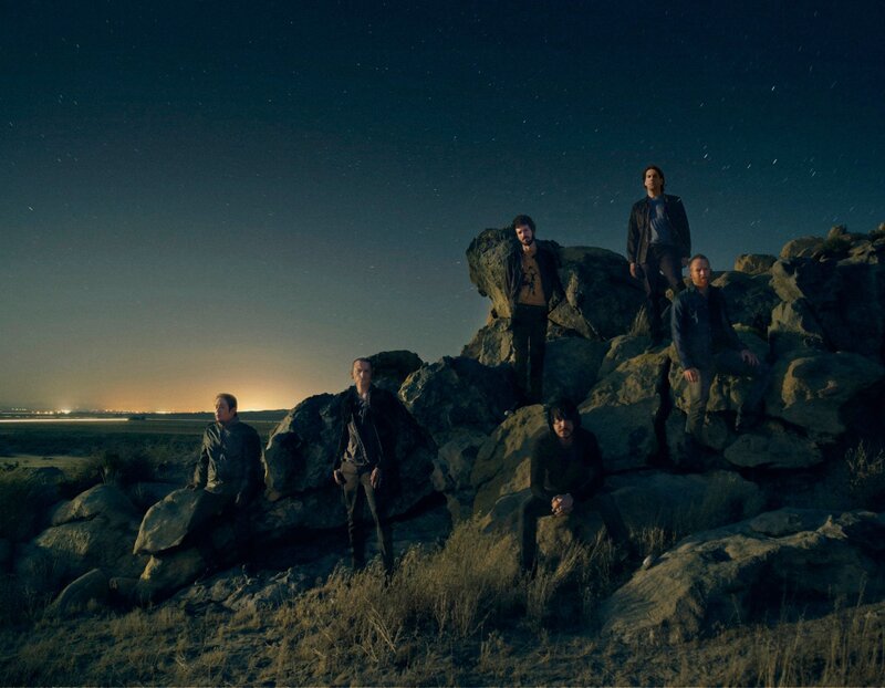 band on rocks at night