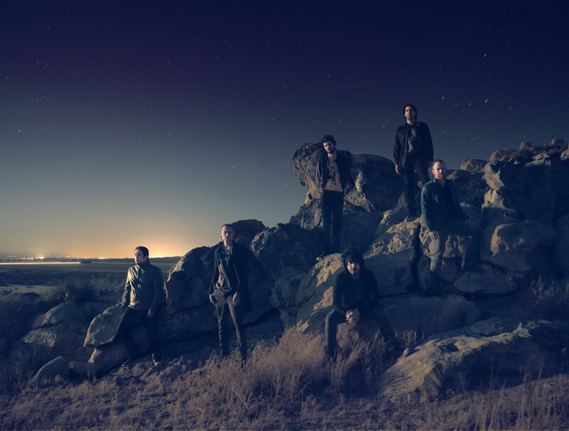 band on rocky hill at night