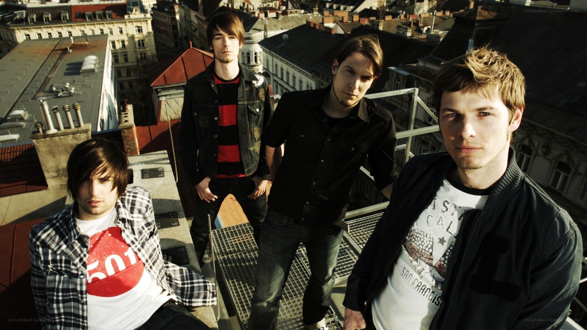 band on rooftop with city view