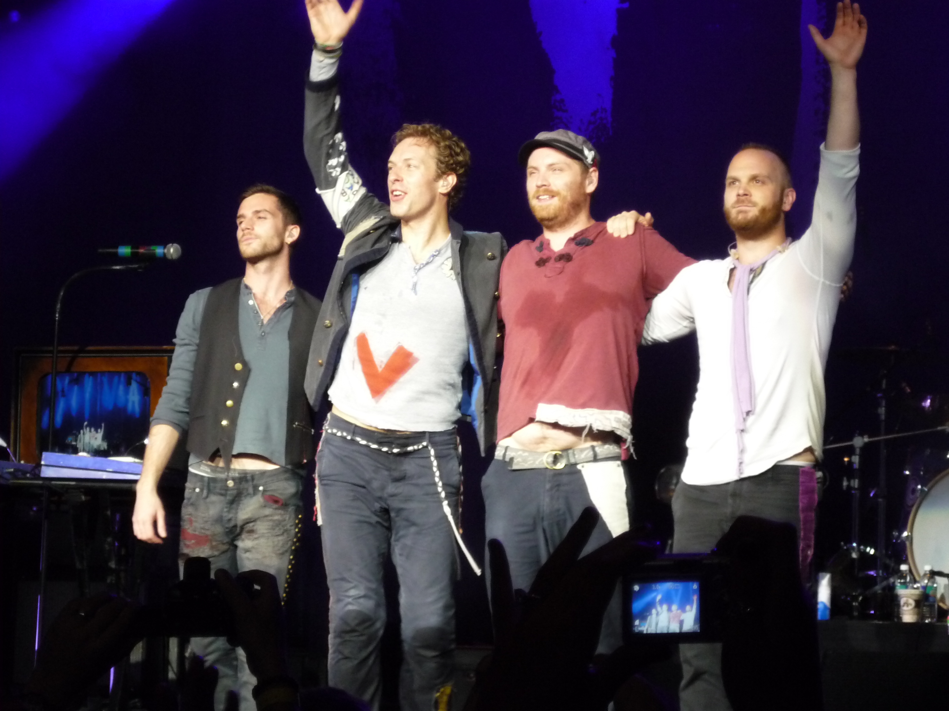 band on stage with crowd