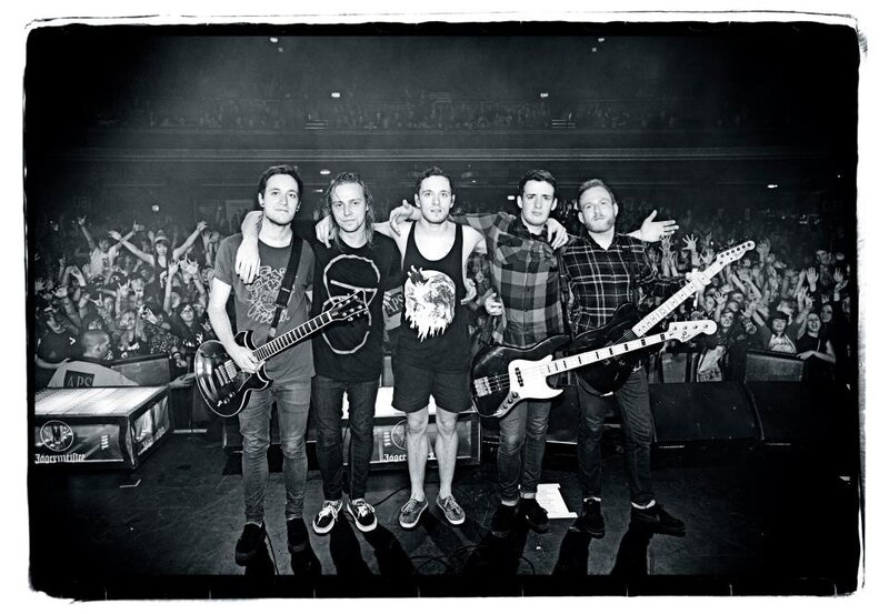 band on stage with crowd