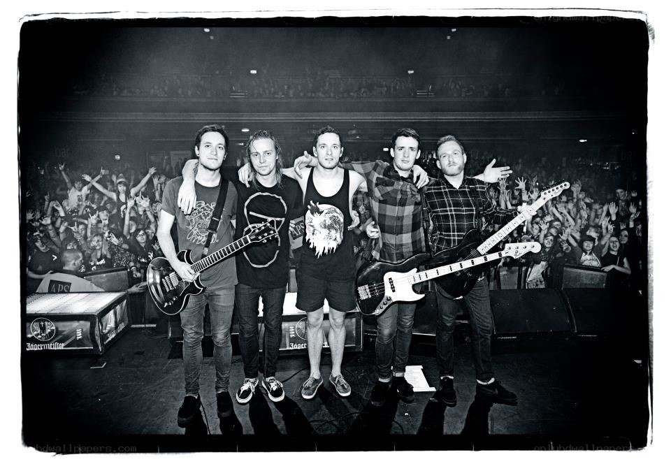 band on stage with crowd
