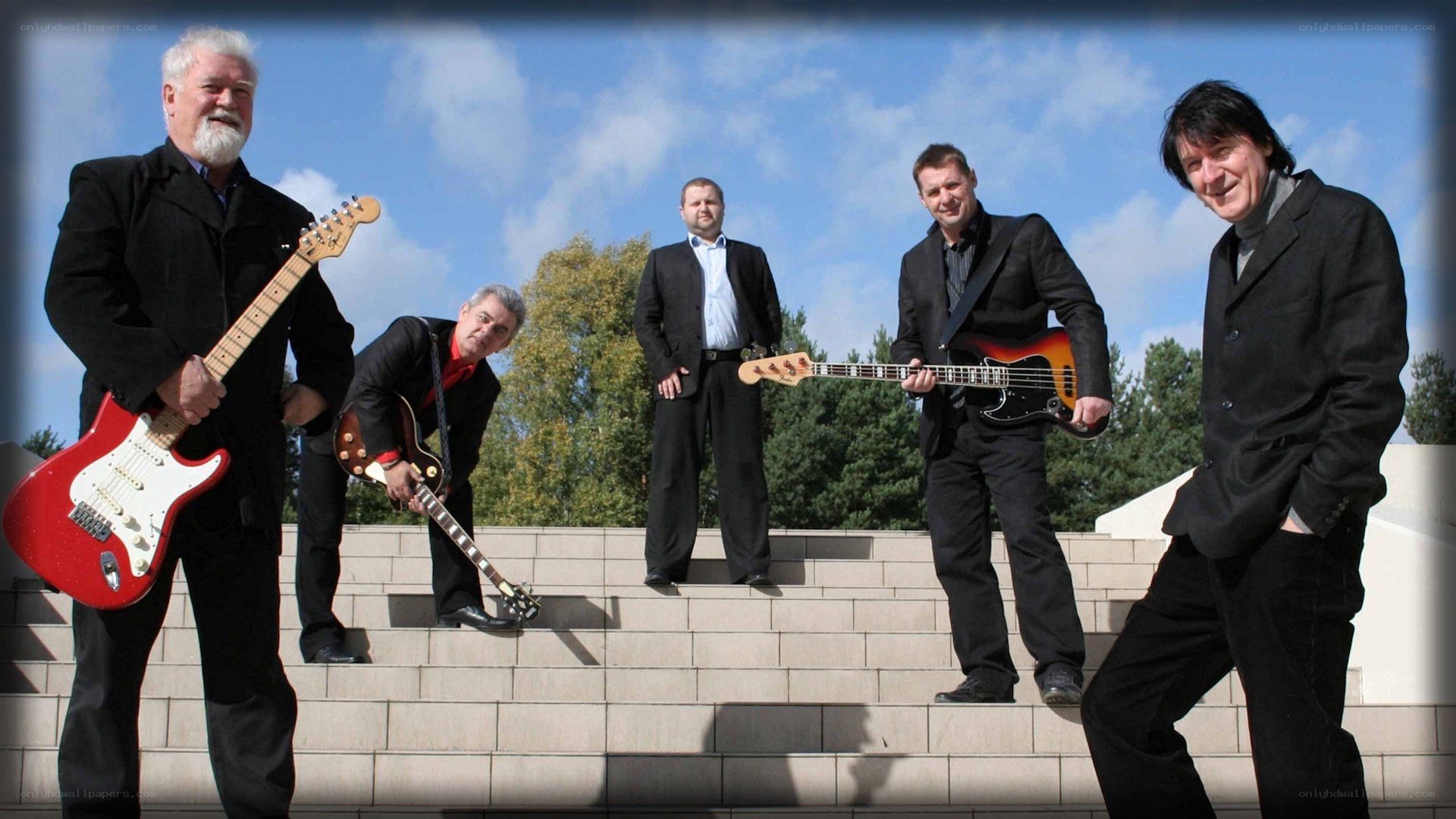 band on steps with guitars