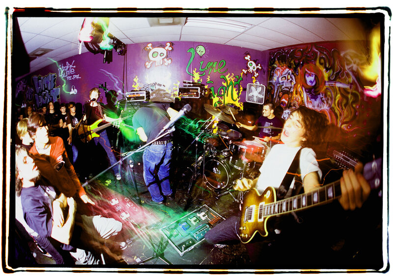 Band performing in a graffiti-covered room