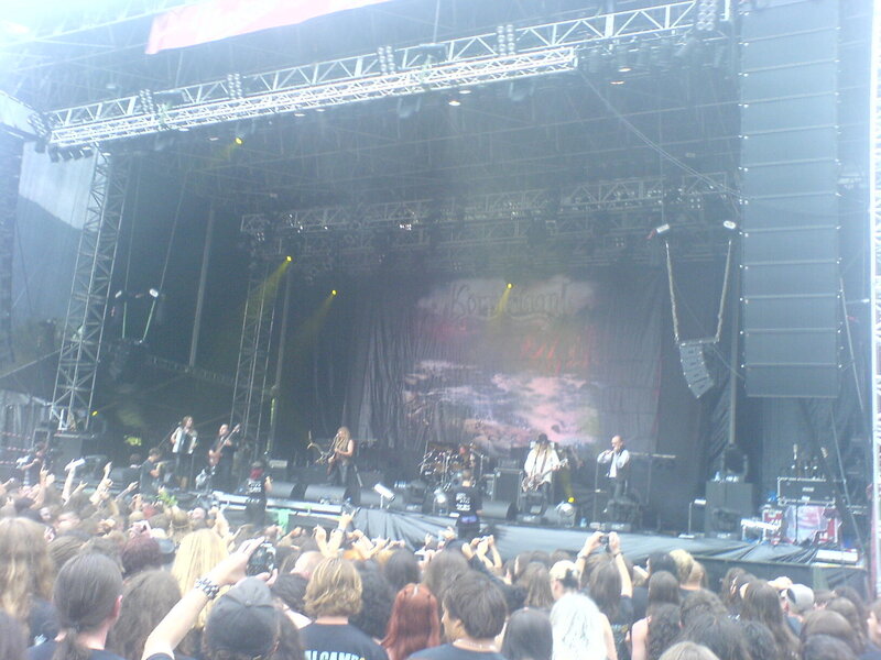 Band Performing on Stage — Black, Energetic, Afternoon, Photograph, Crowd, Musicians