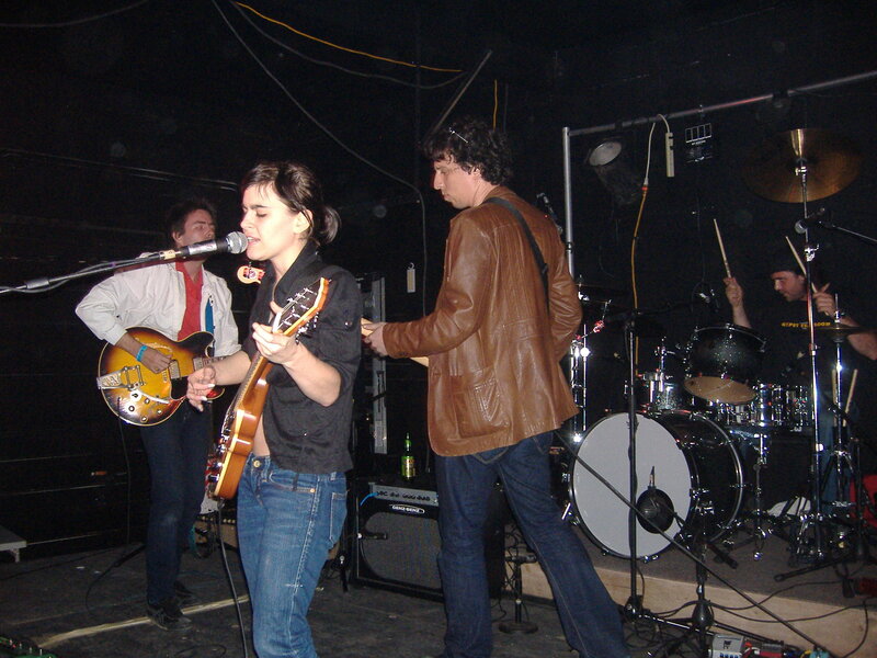 Band Performing on Stage — Black, Energetic, Night, Photograph, Guitar, Drums, Microphone, Brown