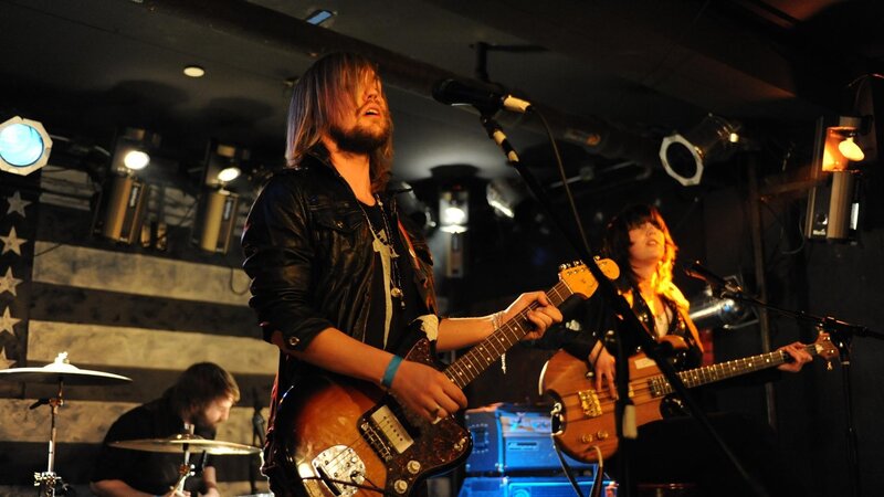 Band Performing on Stage — Black, Energetic, Night, Photograph, Guitar, Drums, Microphone