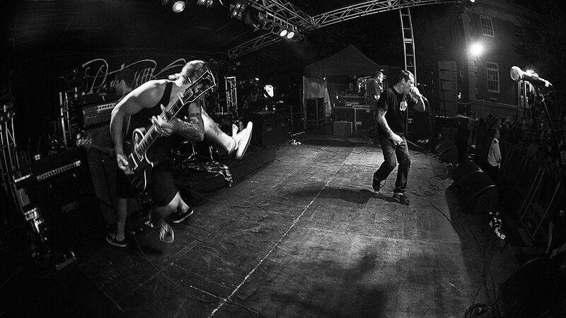 Band Performing on Stage — Black, Energetic, Night, Photograph, Guitarist, Singer