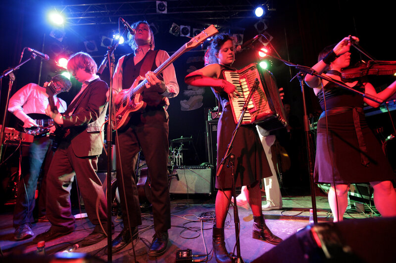 Band Performing on Stage — Black, Energetic, Night, Photograph, Musicians, Instruments, Stage Lights